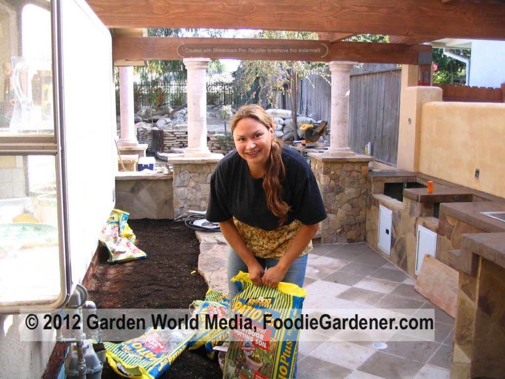 Shirley in her outdoor kitchen and vegetable garden